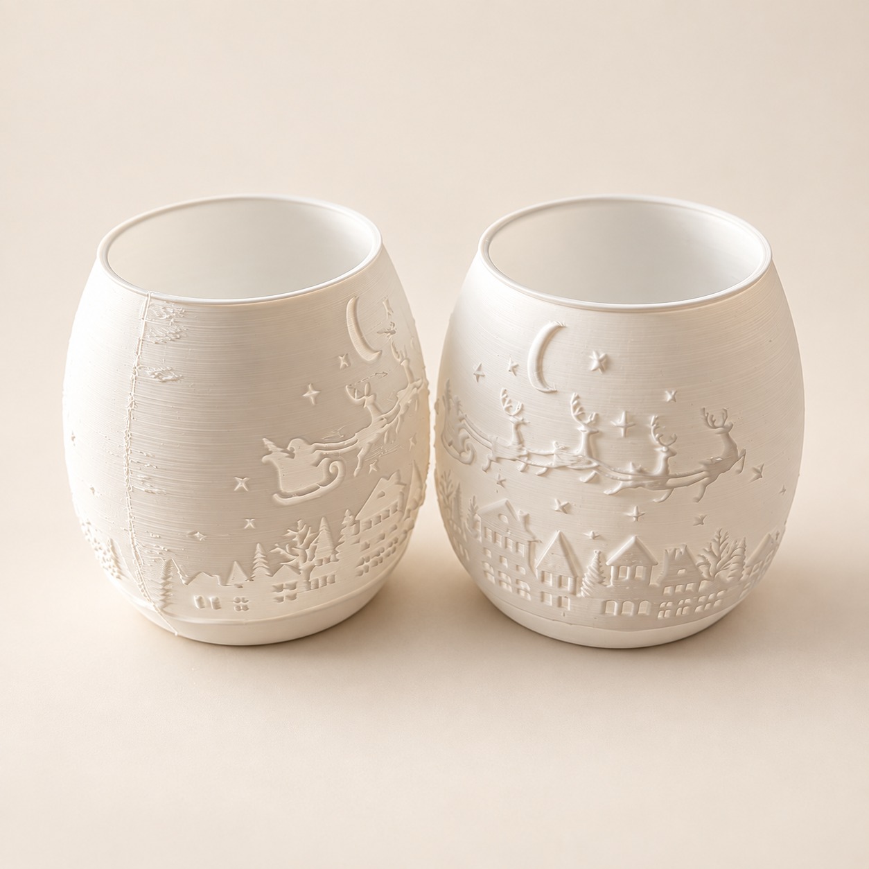 White decorative pots with a raised sleigh, reindeer and winter village scene.