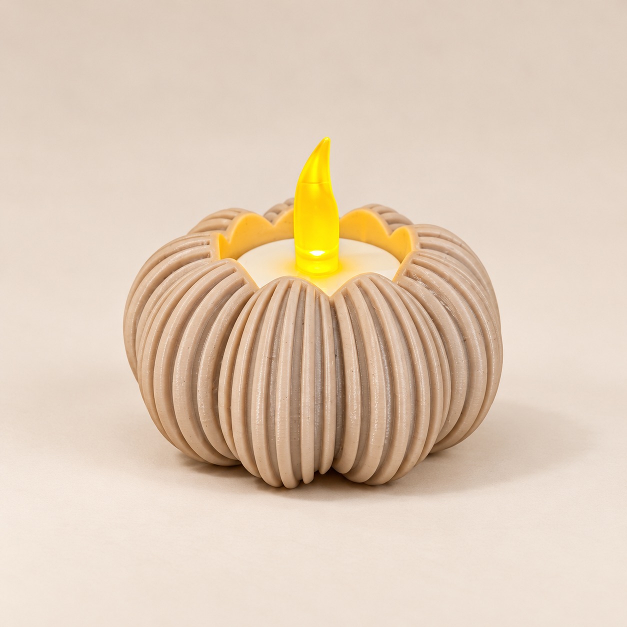 A rounded cream holder with deep curved ribs, shown with a battery-powered LED tealight.