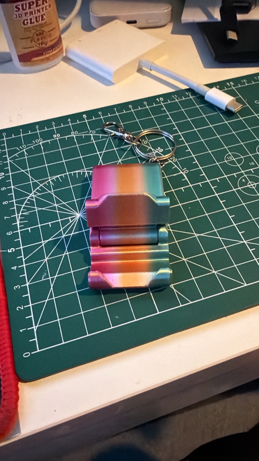 Pocket-sized practicality: A folding phone stand with a keyring attachment.