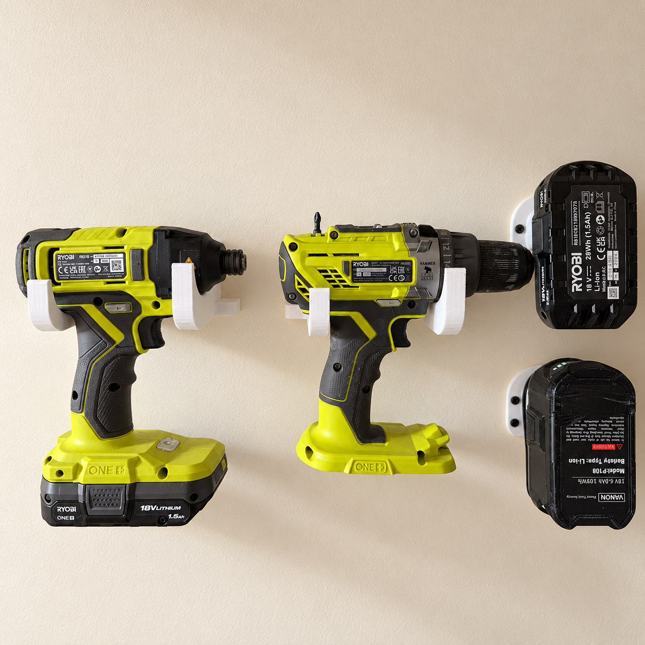 White wall-mounted 3D printed holders supporting two Ryobi power tools, with battery mounts alongside.