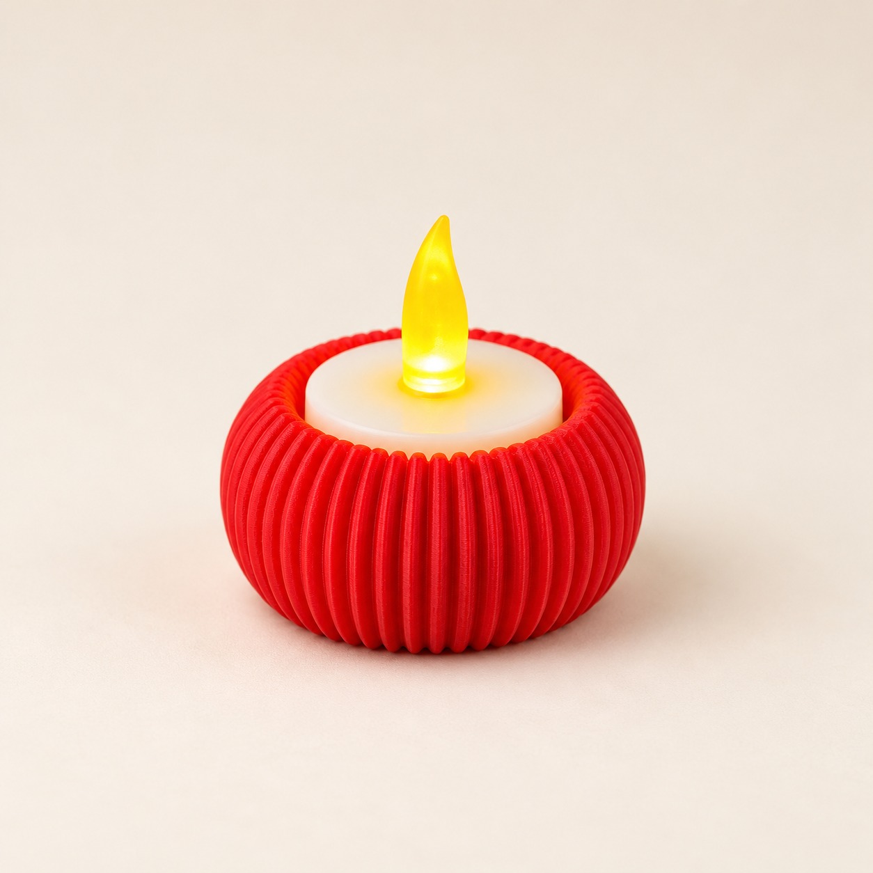 A compact red holder with a ribbed finish, shown with a battery-powered LED tealight.