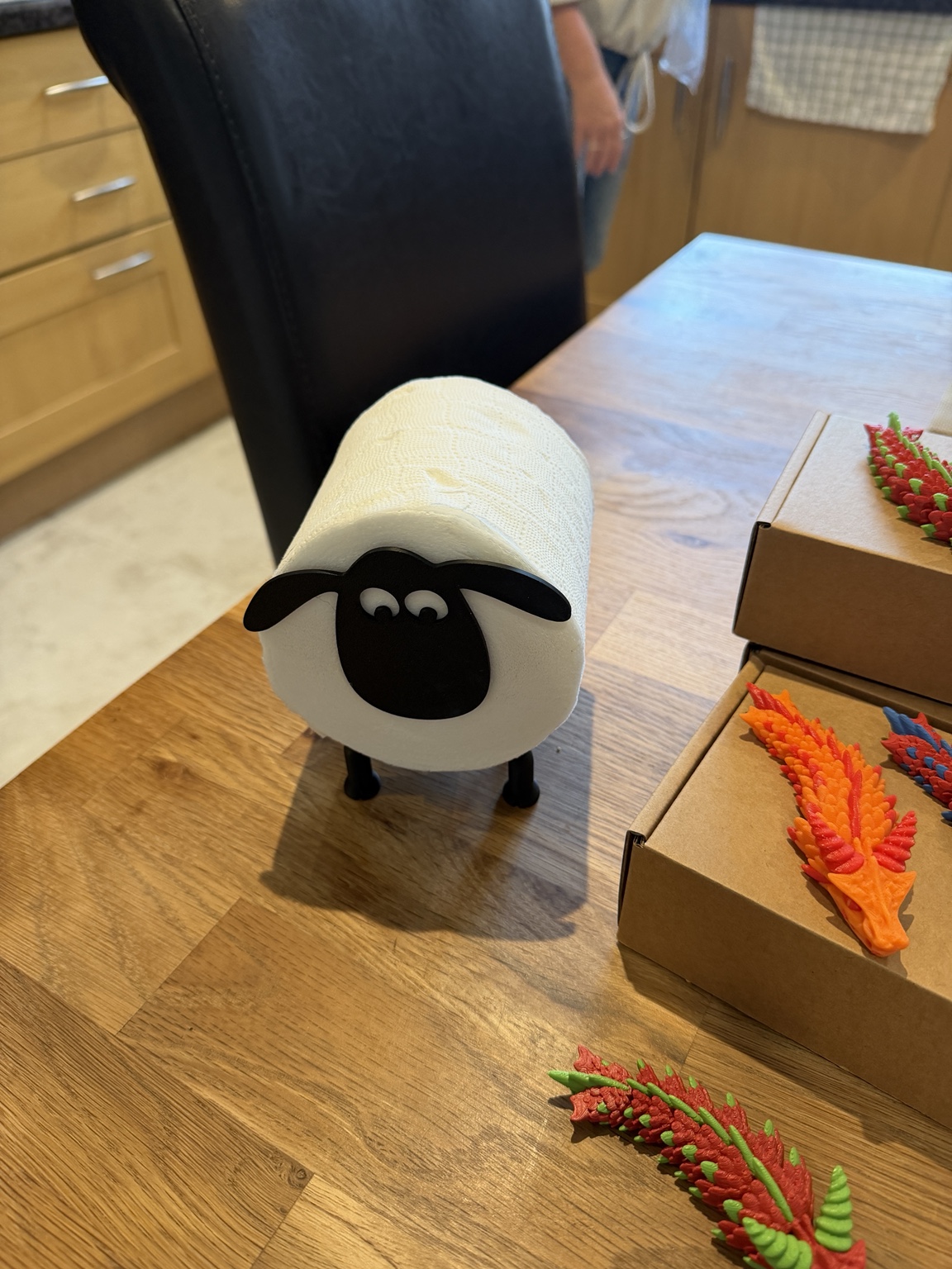 A woolly little helper: A sheep-shaped roll holder with a cheeky face.
